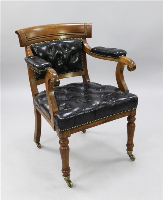 A Victorian oak Holland & Son elbow chair, H.2ft 10in.